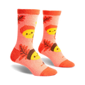 Pair of coral fuzzy socks with an acorn and leaf pattern.  Acorns have smiling faces.  Brown and yellow details.