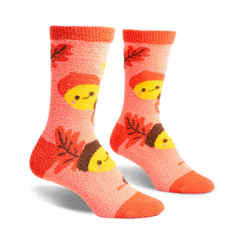 front view of a pair of fuzzy pink socks with brown acorns and yellow smiling faces.