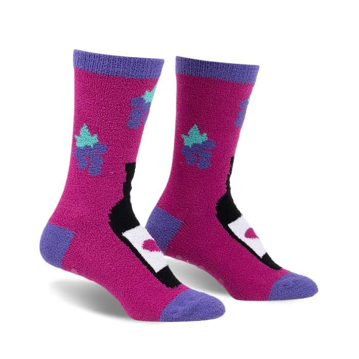 front view of two pink fuzzy socks with a black wine bottle design and purple flowers with teal accents.  the socks have a purple trim around the top.  the image shows the socks slightly angled.