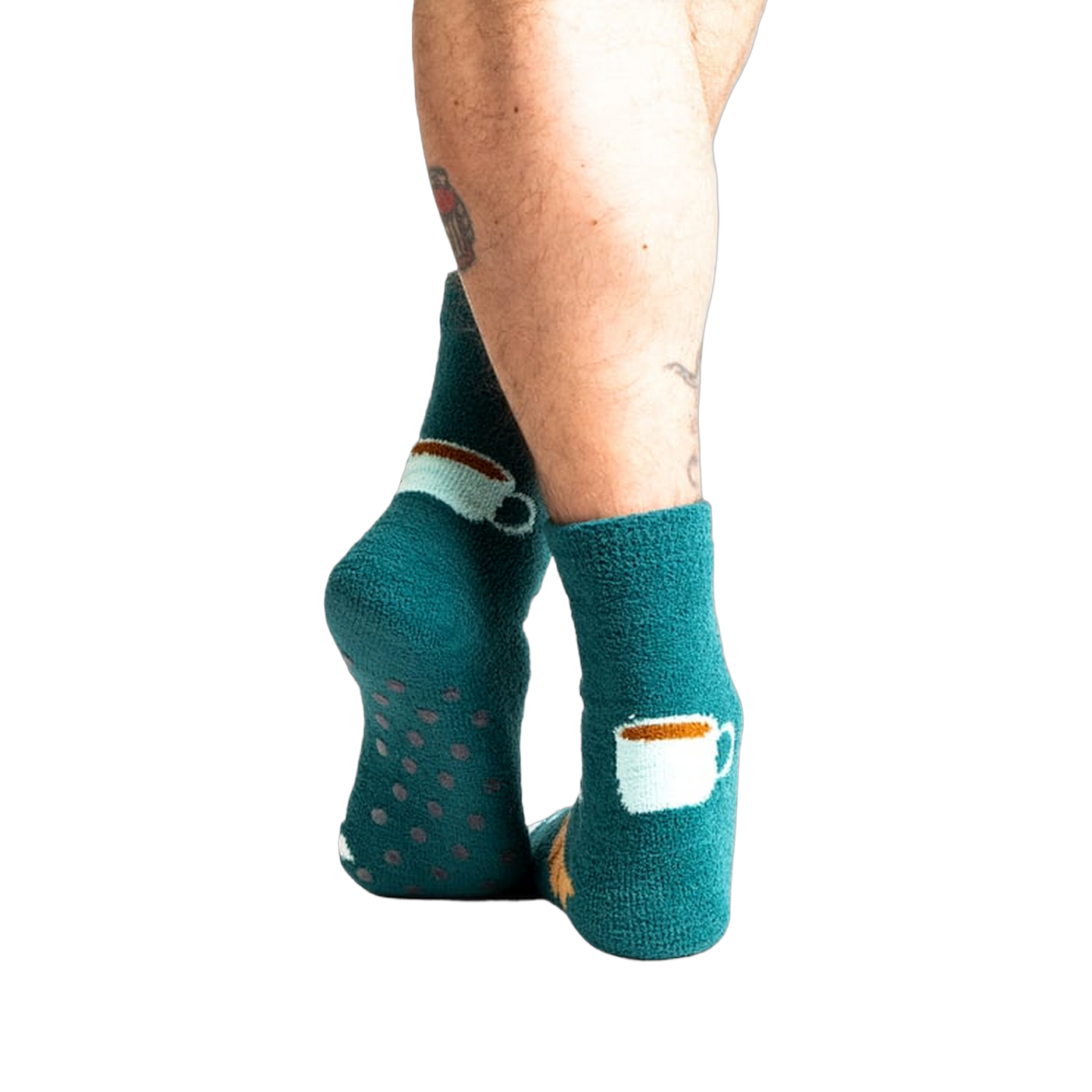 Back view of model wearing teal blue coffee and croissant slipper socks.