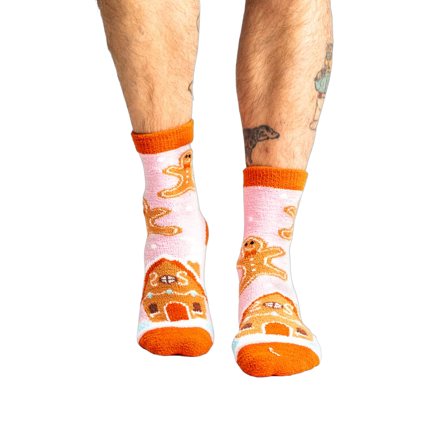 Lifestyle shot of a person wearing the pink gingerbread slipper socks.