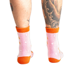 Back view of model wearing the pink and orange gingerbread socks.