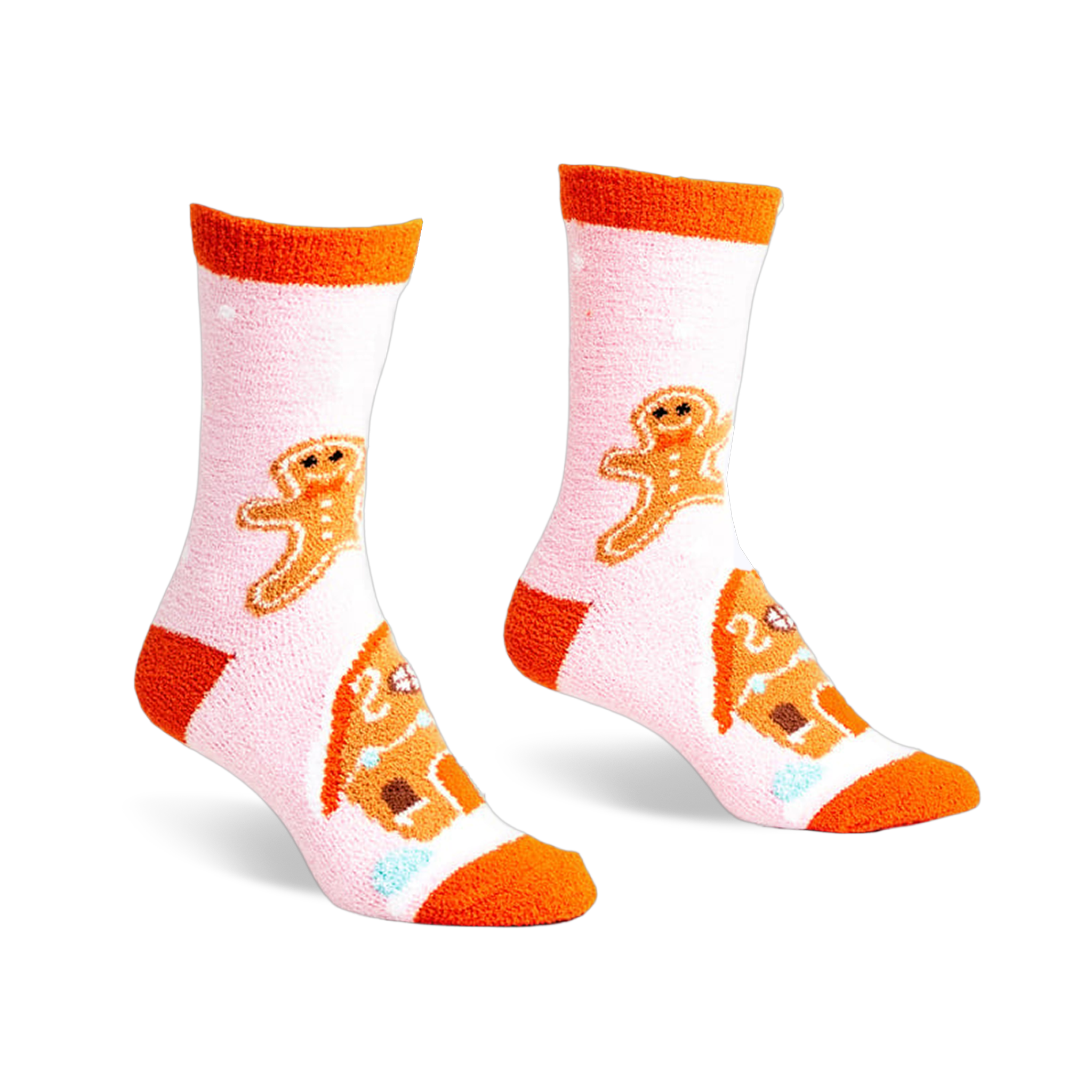 Pair of pink fuzzy slipper socks with orange cuffs. Gingerbread men and houses are embroidered on the socks.