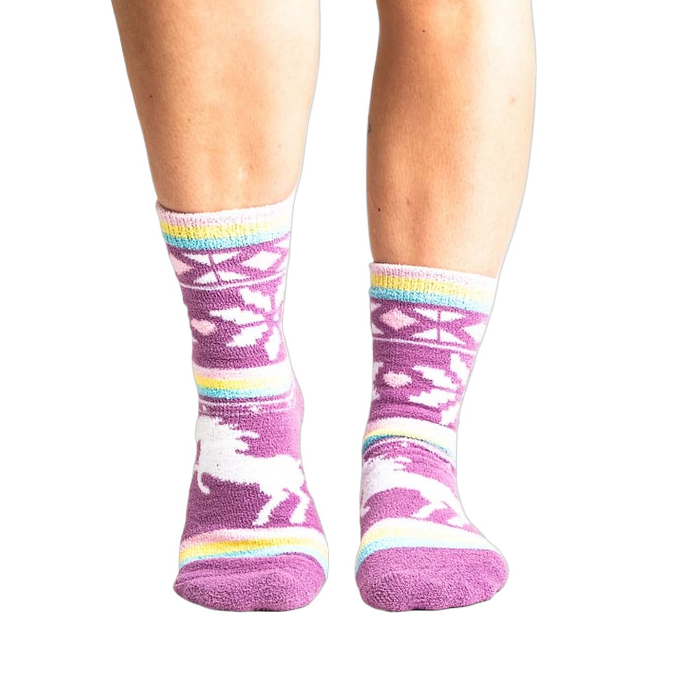 Lifestyle shot: Woman's legs wearing purple unicorn slipper socks.