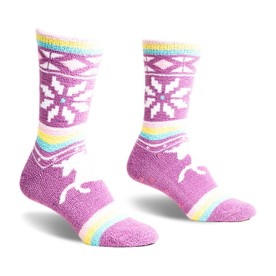 a pair of purple fuzzy socks with a snowflake pattern and a white stripe, pink stripe, and a yellow stripe near the ankle.  the socks are laying flat with the back of the socks facing the viewer.