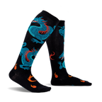 Pair of black knee-high socks with teal dragons and orange flames. Fun and vibrant design.