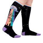 Person wearing a pair of 'The Truth Is Out There' knee-high socks. Shows how they look on.