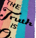 Close-up detail of the 'The Truth Is Out There' text and rainbow graphic on the socks.