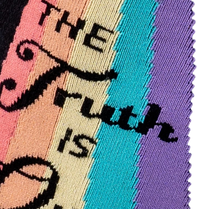Close-up detail of the 'The Truth Is Out There' text and rainbow graphic on the socks.