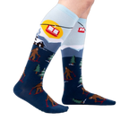 Lifestyle shot: Model wearing the Bigfoot skiing socks, showing the full design.