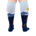 Back view of the socks on a model's legs, showcasing the complete winter scene.
