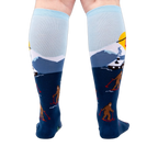 Back view of the socks on a model's legs, showcasing the complete winter scene.