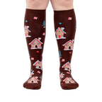 Front view of the socks on a person's legs, highlighting the full design.