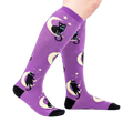 Lifestyle shot showing the socks on a person's legs, showcasing the fit and design.