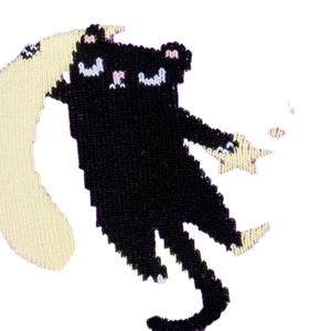 Close-up detail shot of the sock's design, focusing on a cat sitting on a moon.