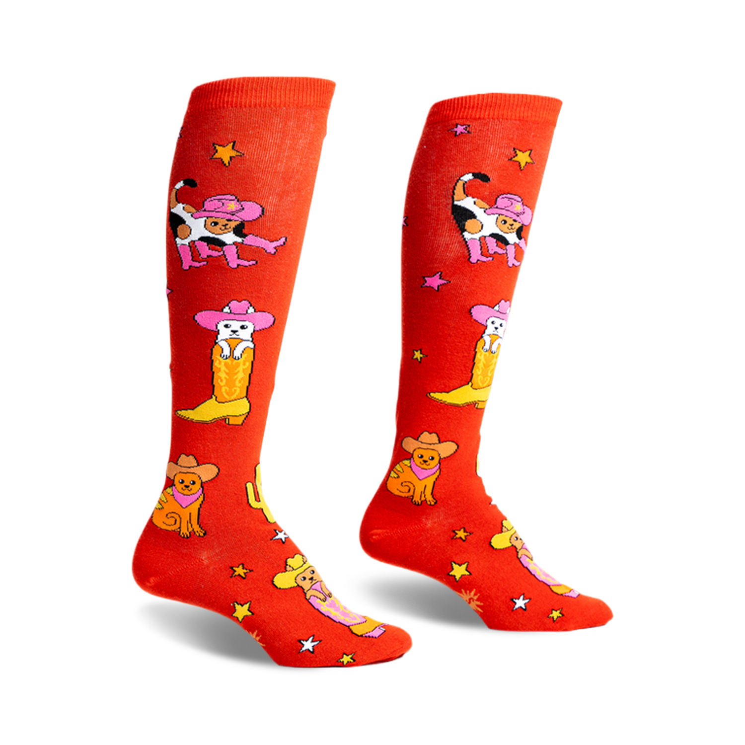 Pair of orange knee-high socks with a fun design of cats wearing cowboy hats and boots.  Stars and cacti are also featured.