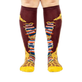Front view of the socks, clearly showing the details of the giraffe and books.