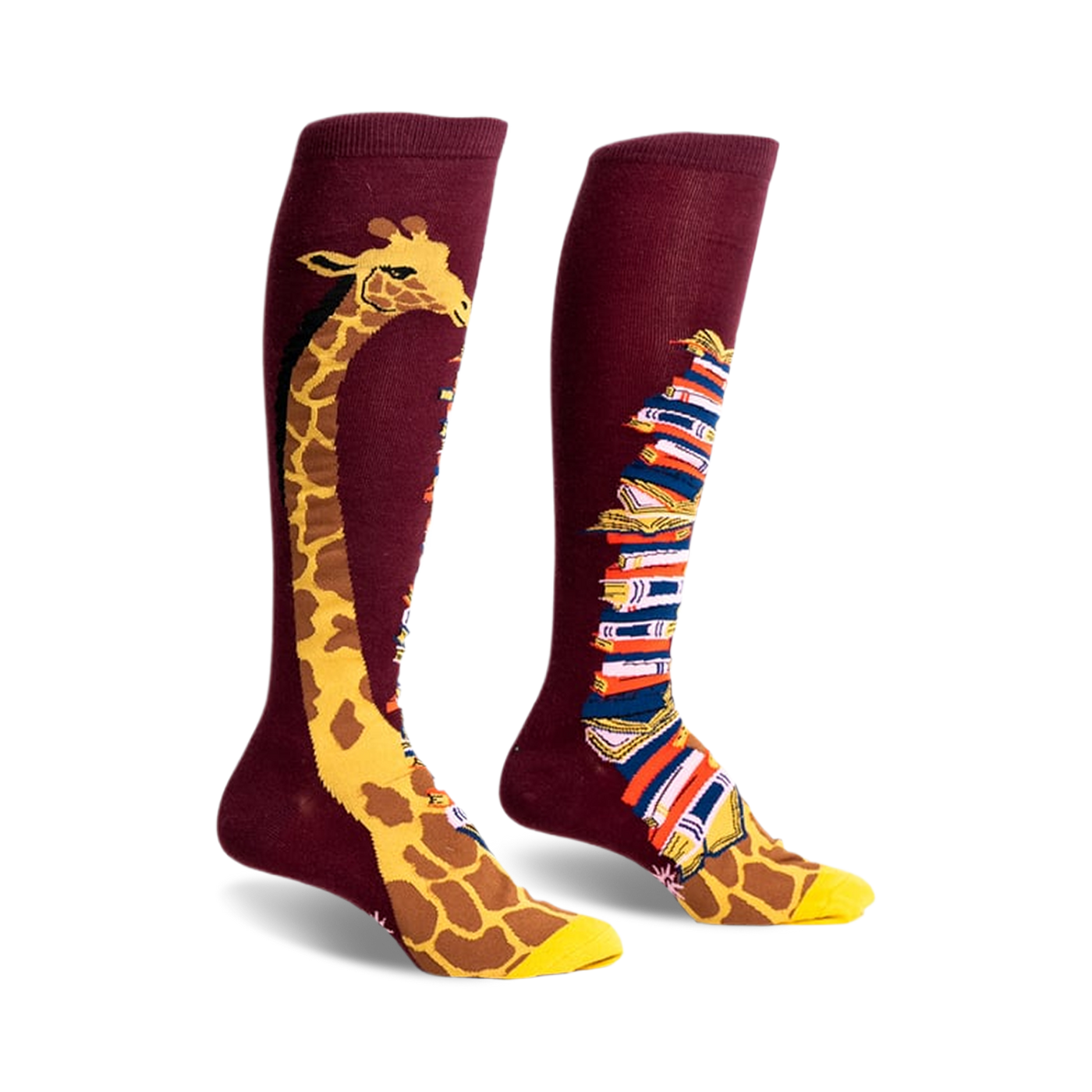 Pair of burgundy knee-high socks. One sock has a giraffe's neck & head; the other, a stack of colorful books.