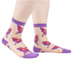 Sheer ankle socks in nude with purple cuffs and colorful butterfly designs. 