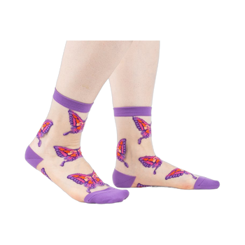 Sheer ankle socks in nude with purple cuffs and colorful butterfly designs. 