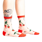 Pair of women's sheer ankle socks with a strawberry and flower design.  Red accents on the cuffs and toes complement the sheer mesh material.