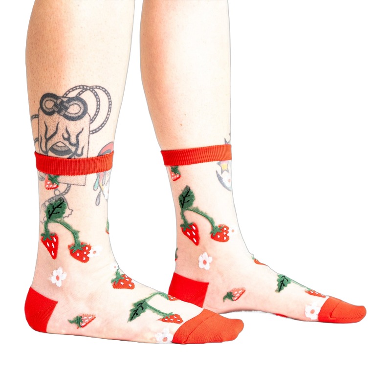 Pair of women's sheer ankle socks with a strawberry and flower design.  Red accents on the cuffs and toes complement the sheer mesh material.