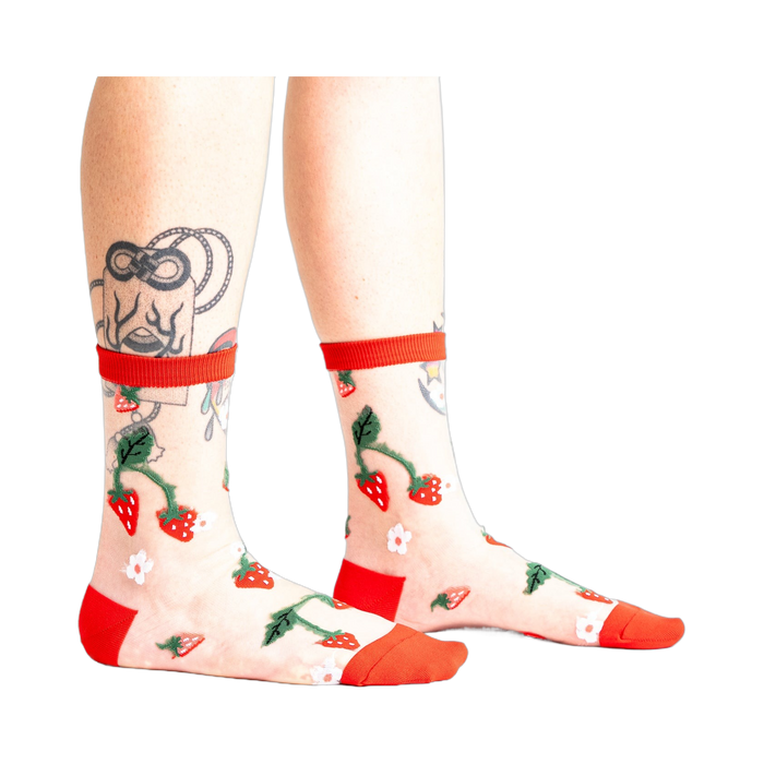 Pair of women's sheer ankle socks with a strawberry and flower design.  Red accents on the cuffs and toes complement the sheer mesh material.