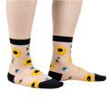 Sheer ankle socks with sunflowers and bees.  Beige background, black cuffs, yellow sunflowers, and blue bees.