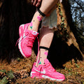 [lf] Pink rose-patterned sheer socks with black polka dots, worn with bright pink sneakers in a forest setting.