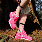[lf] Pink rose-patterned sheer socks with black polka dots, worn with bright pink sneakers in a forest setting.