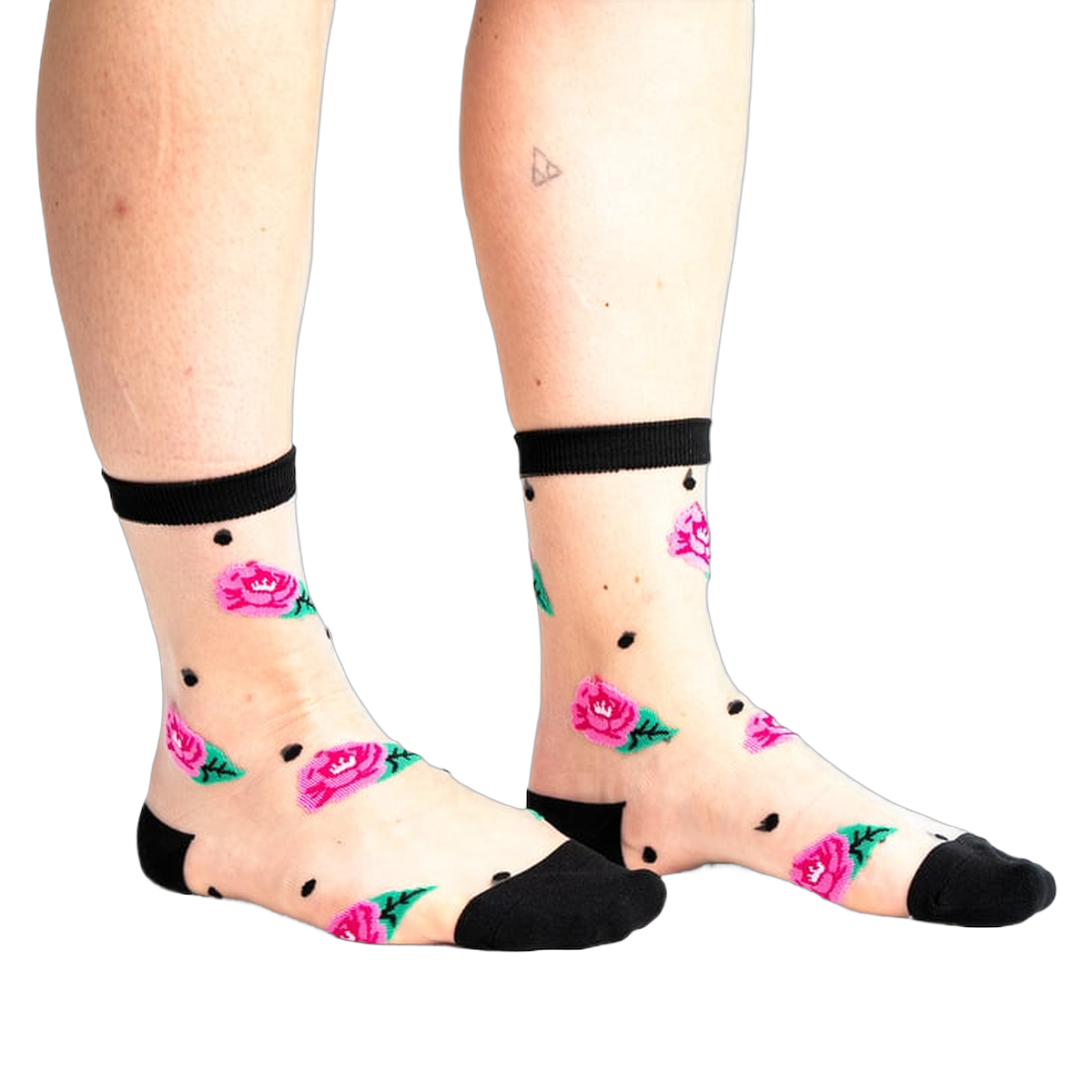 Sheer ankle socks with pink roses, green leaves, and black polka dots on a nude background. Black trim at the top.