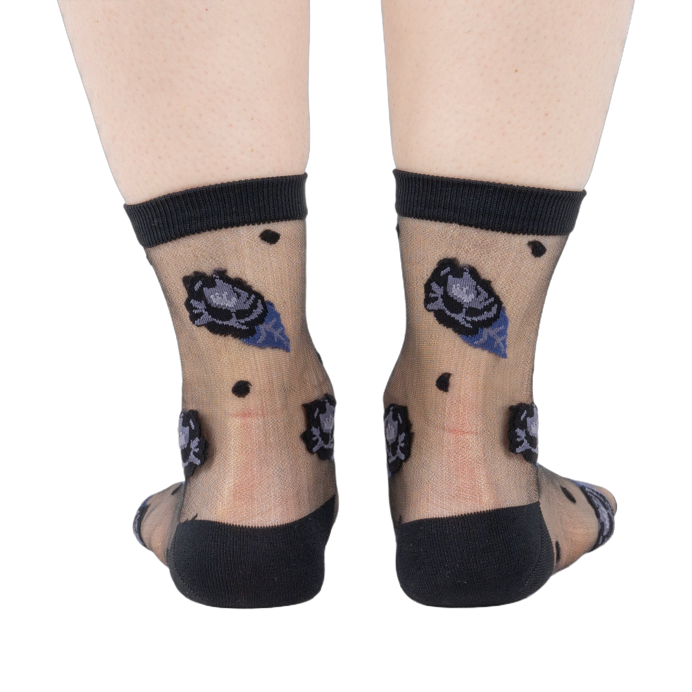 Rear view of legs wearing sheer black ankle socks with dark blue and black rose patterns and black dots on a white background.