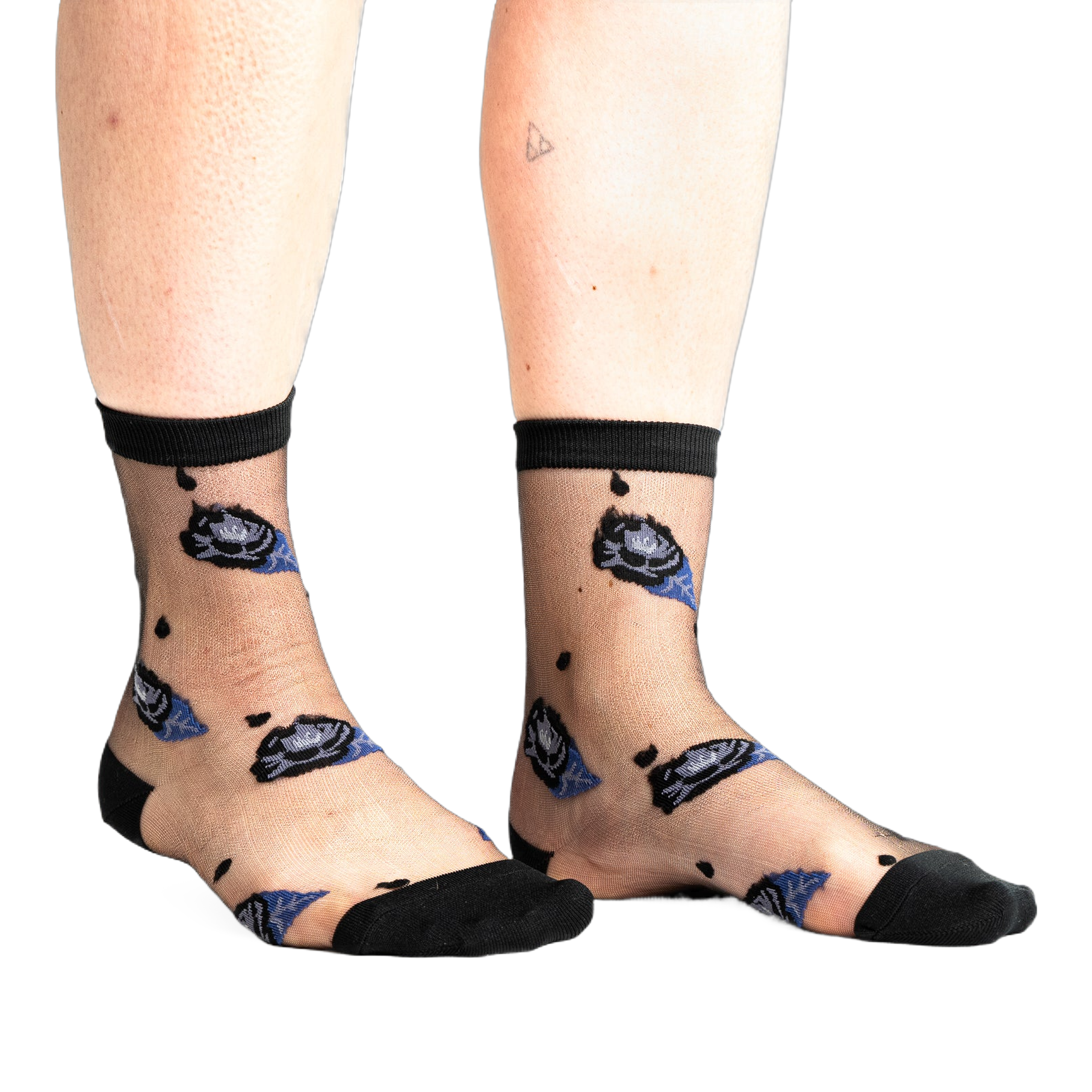 Front view of legs wearing sheer black ankle socks with dark blue and black rose patterns and small black dots on a white background.