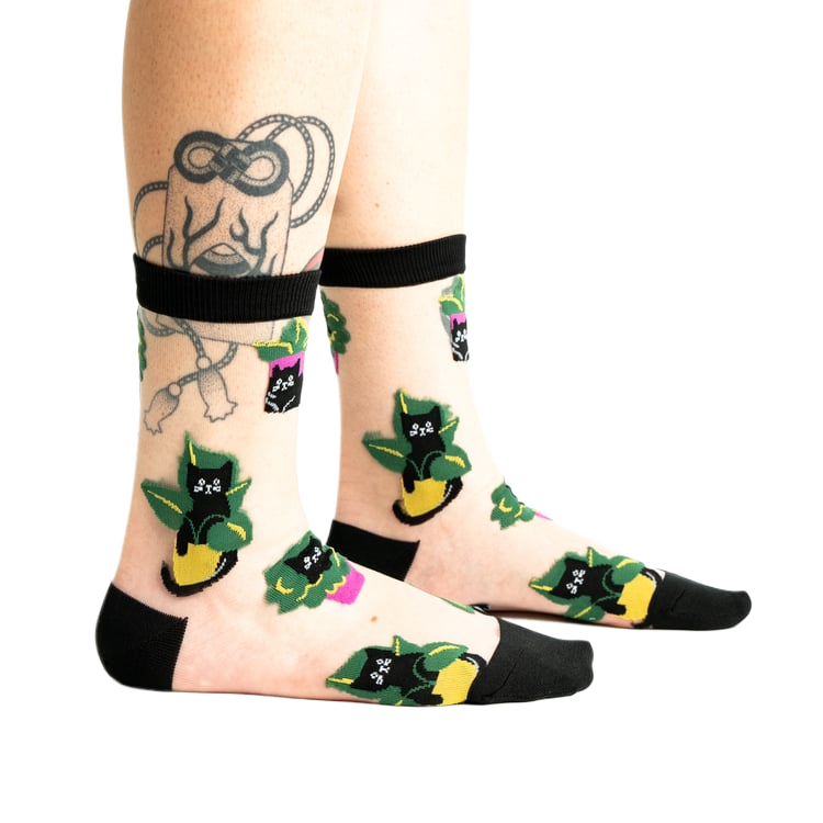 Close-up shot of the socks on a person's legs, showcasing the design detail.