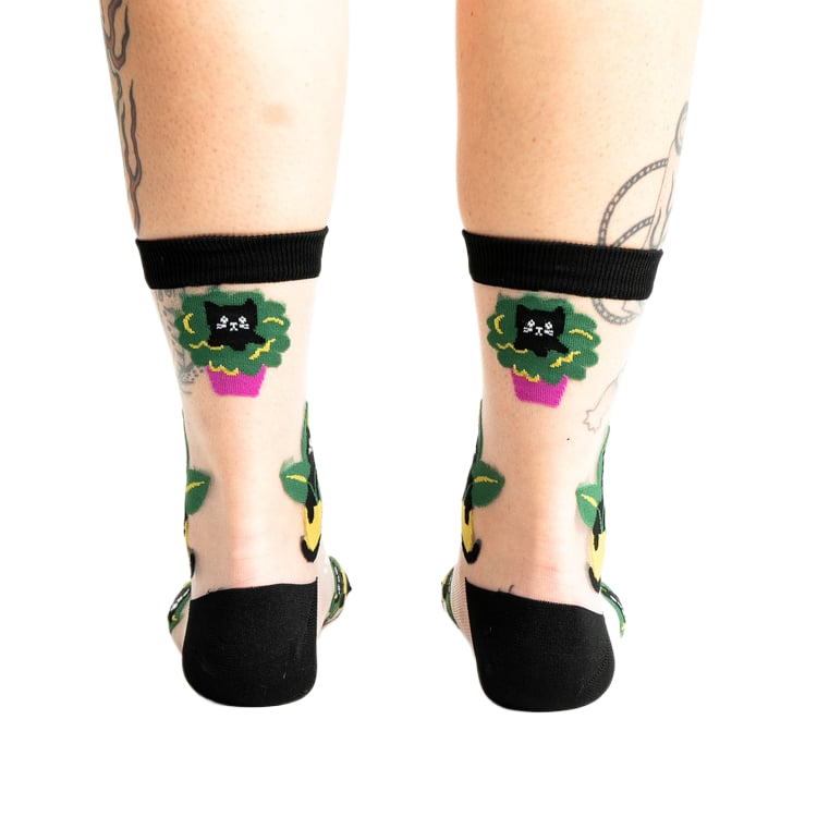Rear view of the socks on a person's legs, emphasizing the back design.