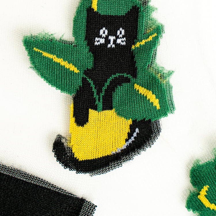 Detailed close-up showcasing the knitted design of a single black cat in a pot on the sheer sock fabric.
