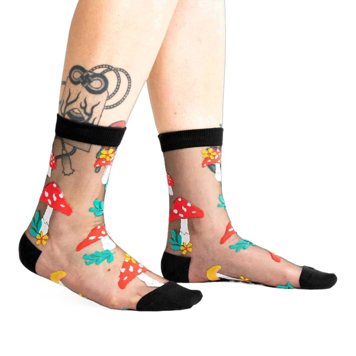 A pair of women's black sheer ankle socks adorned with red and white mushroom and flower designs. 