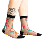 A pair of women's black sheer ankle socks adorned with red and white mushroom and flower designs. 