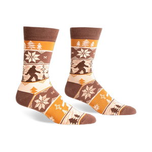 Brown, beige, and orange crew socks with a Bigfoot Fair Isle pattern.  Snowflakes and trees add to the wintery design.
