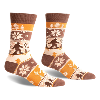 pair of brown, yellow and white socks with a bigfoot design, side view.