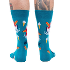 Back view of teal socks with shark and food design on a person's legs. 