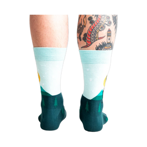 Back view of the Star Buck socks on a person's legs, highlighting the design's continuation around the heel and ankle.
