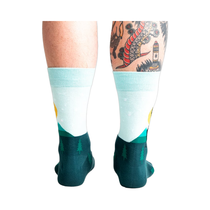 Back view of the Star Buck socks on a person's legs, highlighting the design's continuation around the heel and ankle.