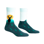 Pair of teal and mint crew socks featuring a black deer silhouette against a yellow sun and teal mountains.  Small pine trees cover the bottom.