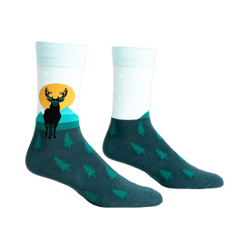 Pair of teal and mint crew socks featuring a black deer silhouette against a yellow sun and teal mountains.  Small pine trees cover the bottom.