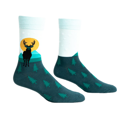 front view of a pair of socks with a deer and sunset graphic. the socks are teal with green trees.