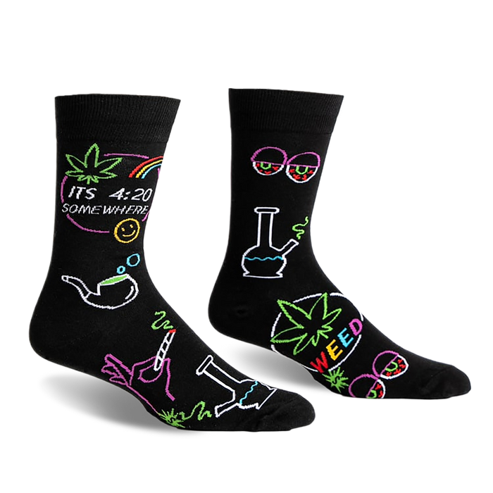 front view of two black socks with colorful marijuana themed designs. one sock has a marijuana leaf, the words gç£its 4:20 somewheregç¥, a rainbow, a smiley face, a smoking pipe, a hand holding a joint and a bong. the other sock has a bong, a marijuana leaf with the word gç£weedgç¥, a pair of glasses with red eyes, and a marijuana leaf.