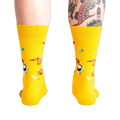 Rear view of the yellow fried chicken socks on a person's legs.