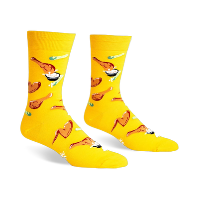 A pair of yellow crew socks with a fun pattern of fried chicken and dipping sauce.  The design is playful and colorful.