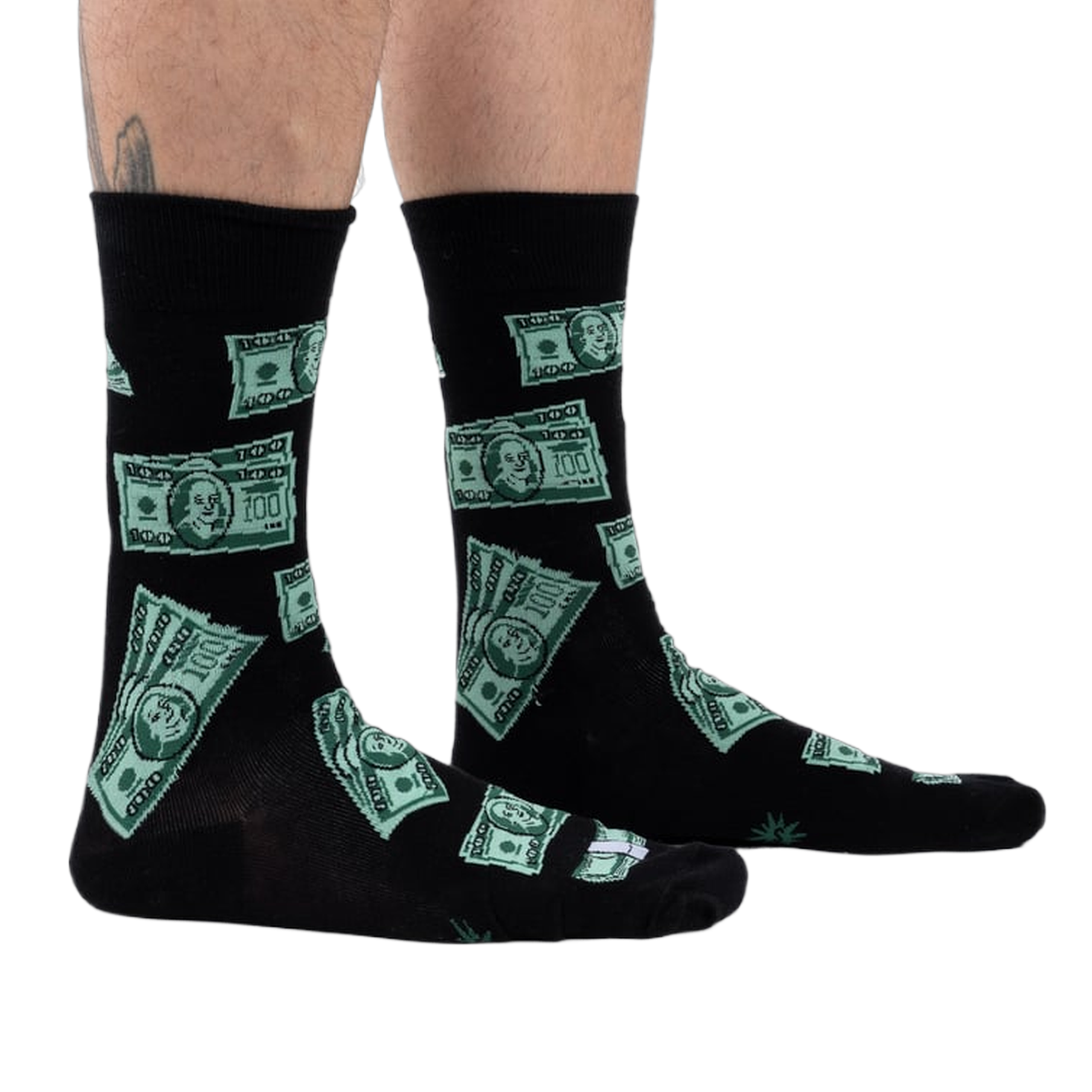 Lifestyle shot of model's legs wearing the black crew socks with a green $100 bill pattern.